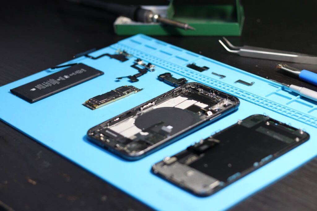 Disassembled smartphone with repair tools on a workbench