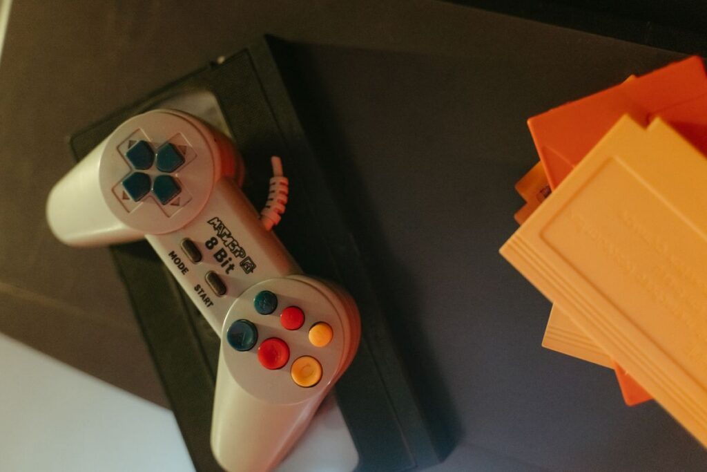 Retro game controller beside classic game cartridges